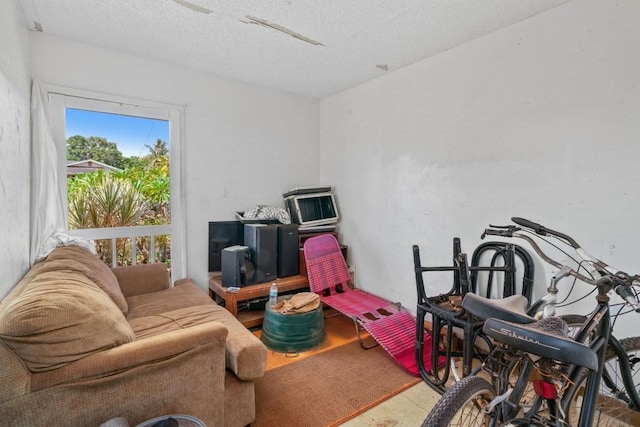 workout room with a textured ceiling, tile floors, and a wealth of natural light