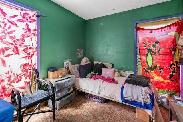 carpeted bedroom featuring a textured ceiling