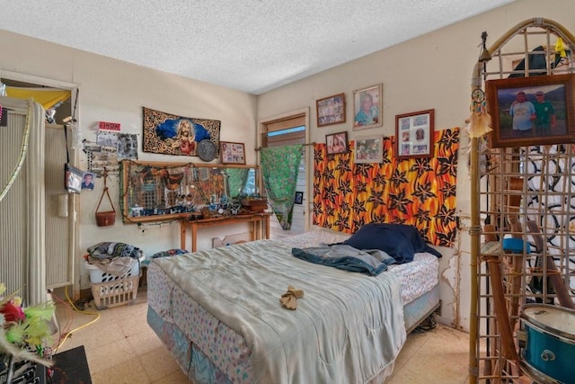 bedroom featuring light tile floors and a textured ceiling