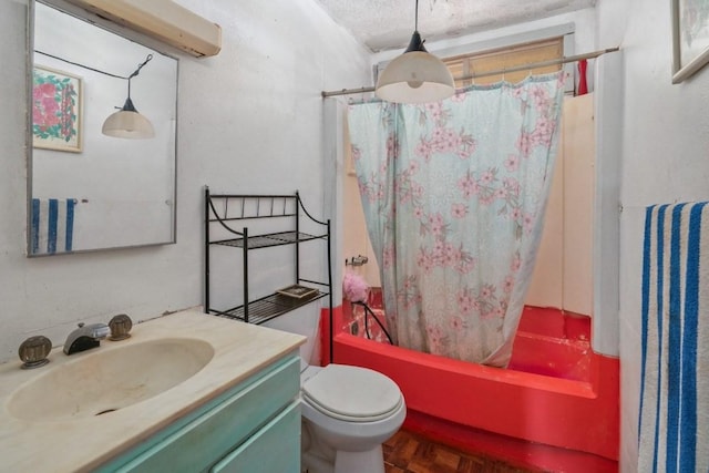 full bathroom featuring toilet, vanity, a textured ceiling, and shower / tub combo