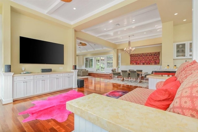 living room featuring light wood-type flooring, beam ceiling, recessed lighting, and ceiling fan with notable chandelier