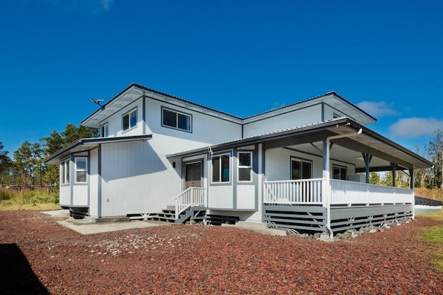 rear view of property with a porch