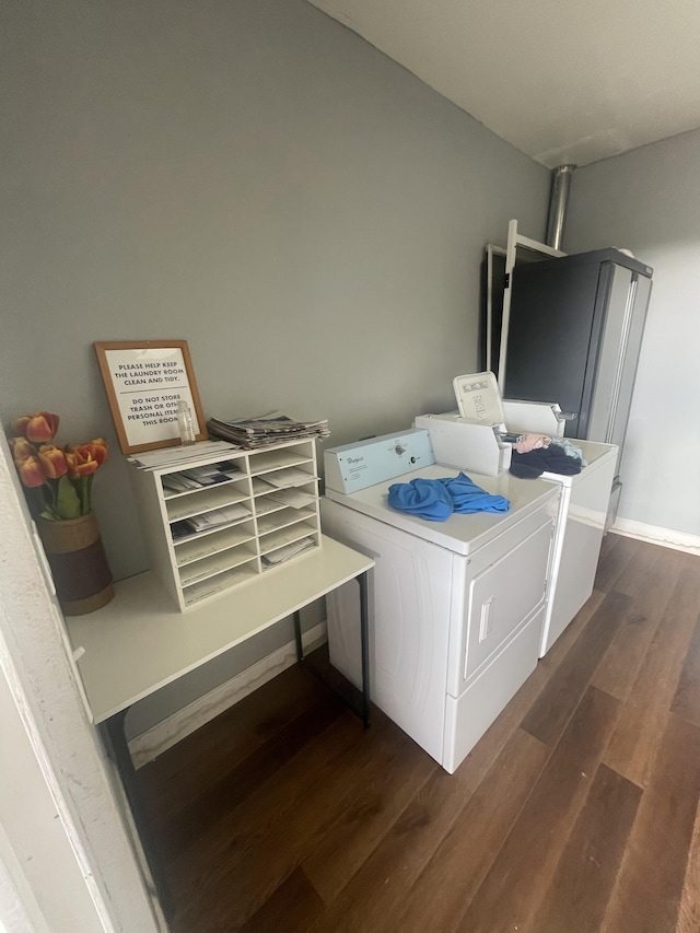 laundry room with dark wood-style floors, laundry area, separate washer and dryer, and baseboards