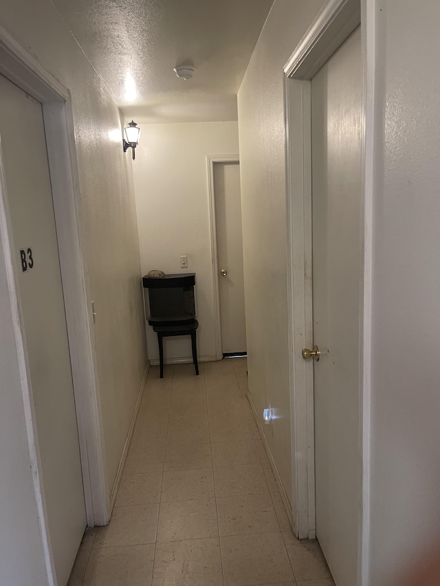 corridor with light tile patterned floors