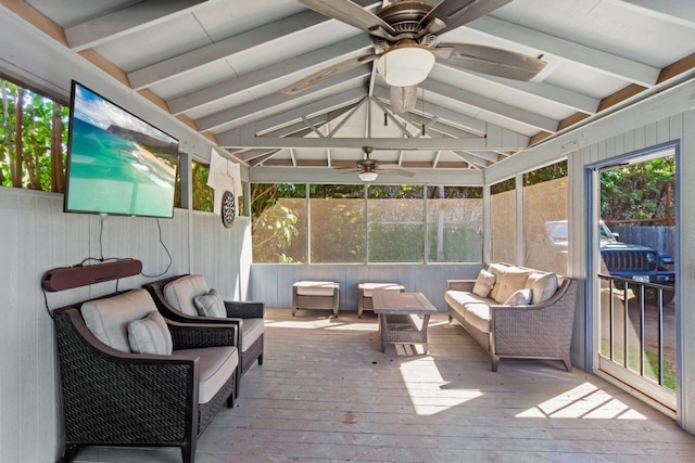 sunroom / solarium with ceiling fan, vaulted ceiling with beams, and plenty of natural light