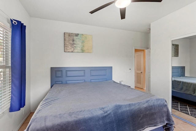 bedroom featuring light tile floors and ceiling fan