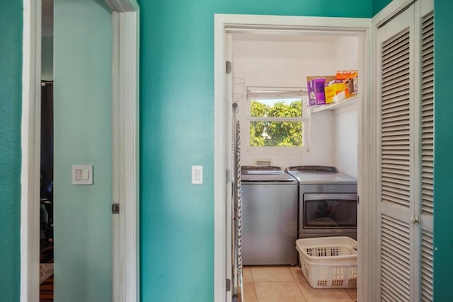 laundry area featuring washer hookup, washing machine and dryer, and light tile floors