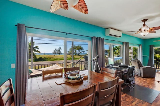 dining area with a wall unit AC and ceiling fan