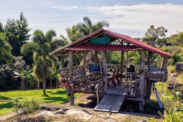 wooden terrace featuring a gazebo and a lawn