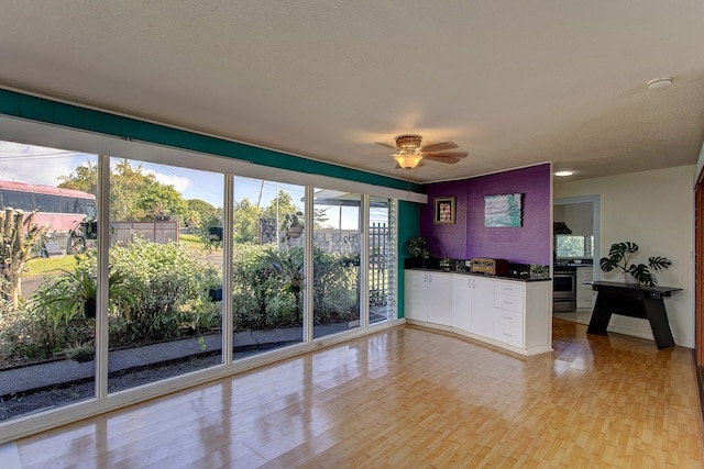 unfurnished living room with light hardwood / wood-style floors and ceiling fan