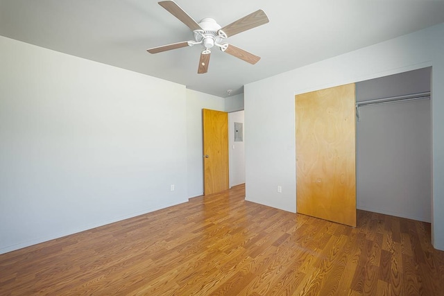 unfurnished bedroom with ceiling fan, light hardwood / wood-style floors, and a closet