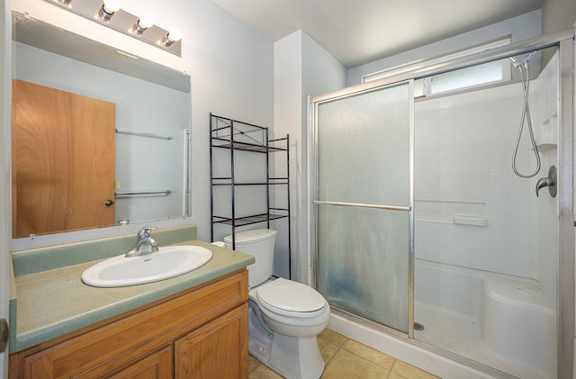 bathroom with walk in shower, tile floors, oversized vanity, and toilet