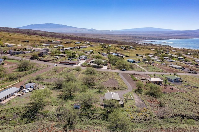 drone / aerial view featuring a water and mountain view