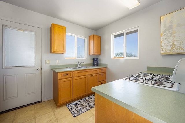 kitchen featuring sink, light tile floors, and a wealth of natural light