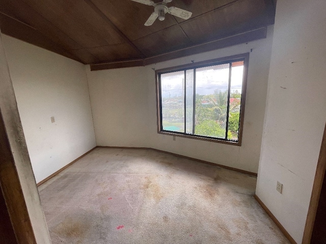 unfurnished room featuring ceiling fan, a wealth of natural light, and light colored carpet