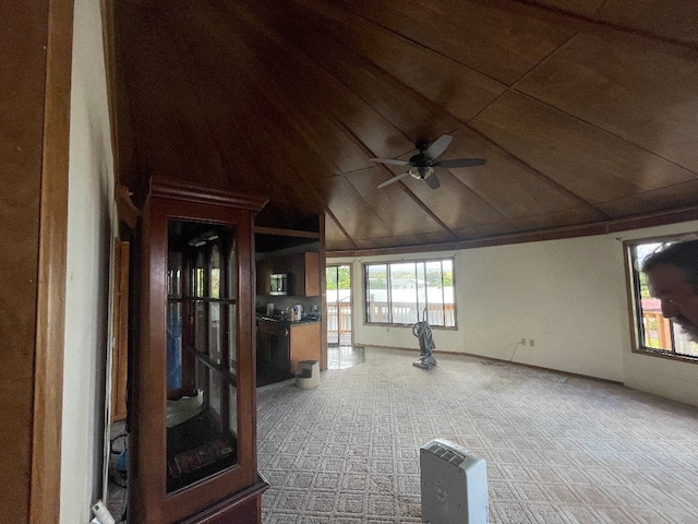 interior space with ceiling fan and lofted ceiling