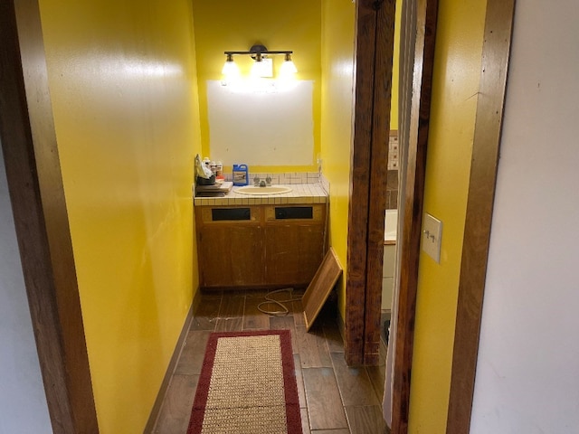 bathroom with hardwood / wood-style floors, toilet, and vanity