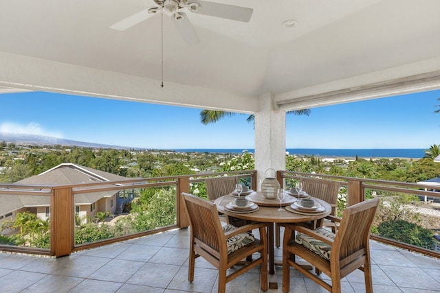 view of terrace featuring a balcony, ceiling fan, and a water view