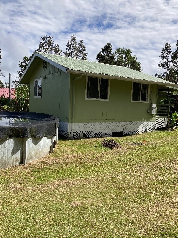 exterior space with a yard and a covered pool