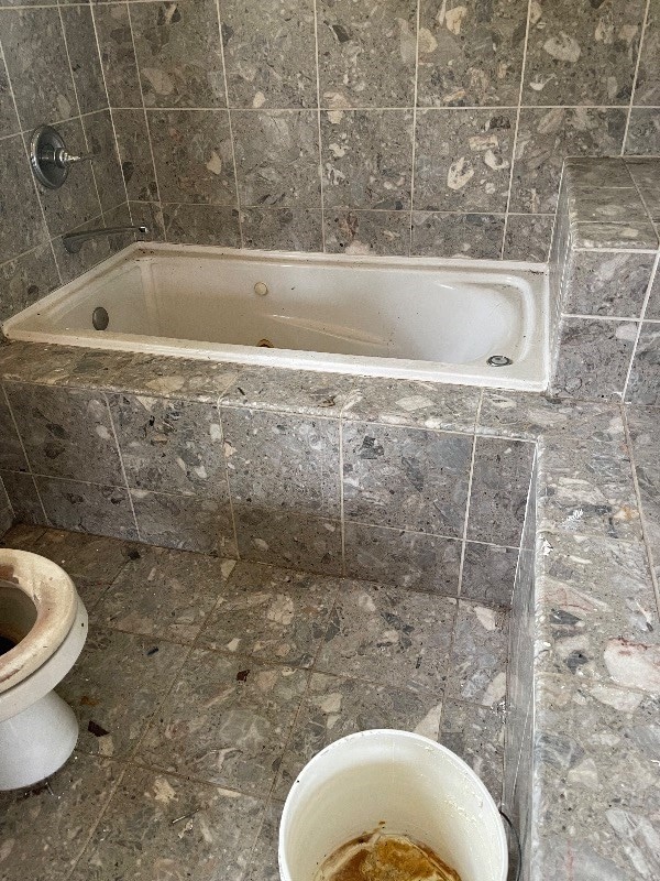 bathroom with toilet and tile flooring