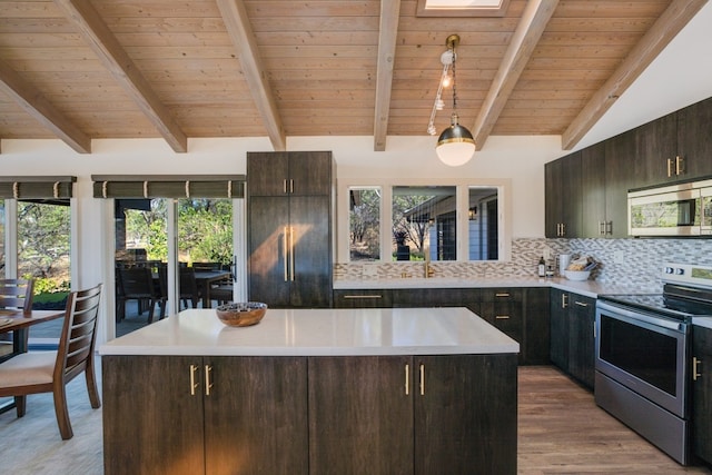 kitchen featuring backsplash, a center island, stainless steel appliances, and plenty of natural light