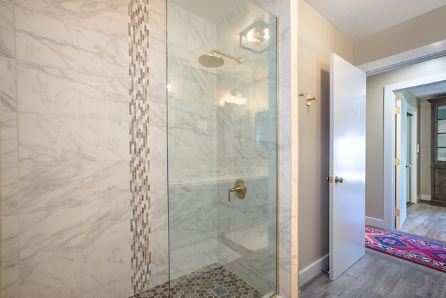 bathroom featuring hardwood / wood-style flooring and a shower with shower door