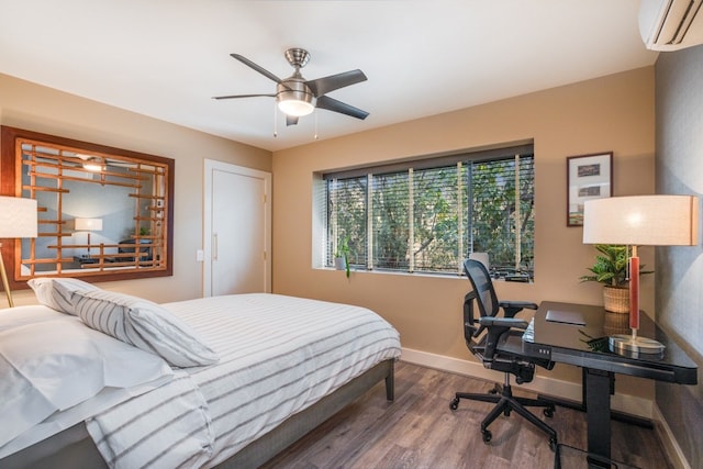 bedroom with hardwood / wood-style floors, ceiling fan, and an AC wall unit