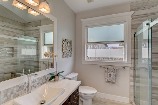 bathroom featuring walk in shower, toilet, and vanity