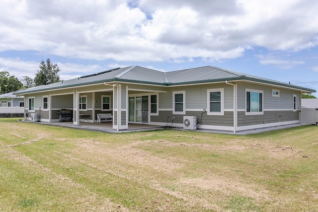 back of property with a patio area and a yard