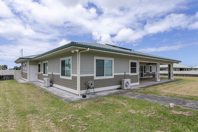 view of front of property with central AC unit, a patio, and a front yard