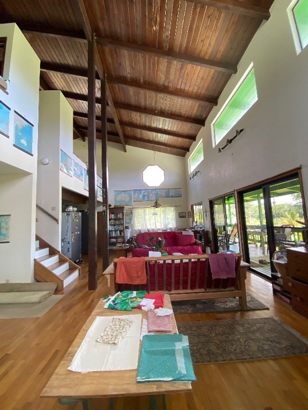 living room featuring high vaulted ceiling, beamed ceiling, wood ceiling, and hardwood / wood-style flooring