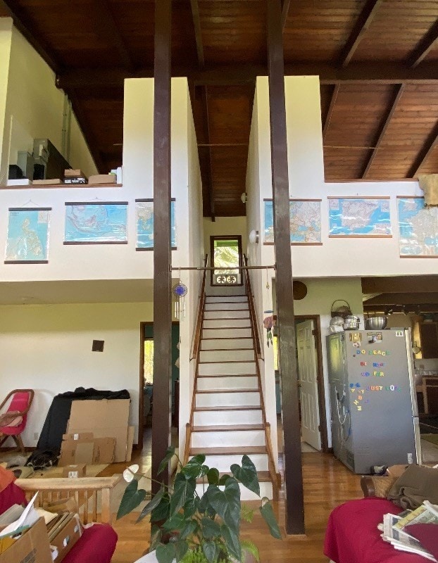 interior space featuring wood ceiling, beam ceiling, high vaulted ceiling, and hardwood / wood-style floors