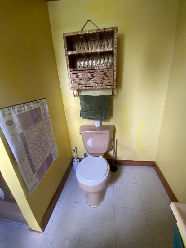 bathroom with tile floors and toilet