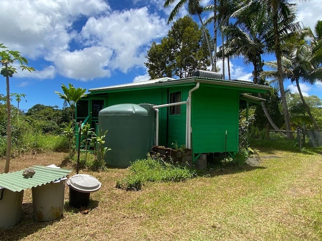 view of side of home featuring a lawn