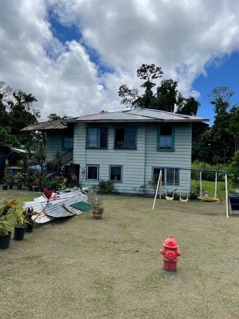 rear view of house with a lawn