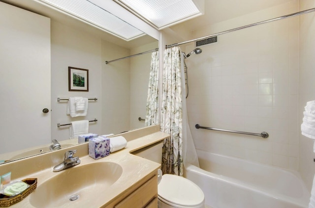 full bathroom featuring shower / tub combo, toilet, and vanity with extensive cabinet space