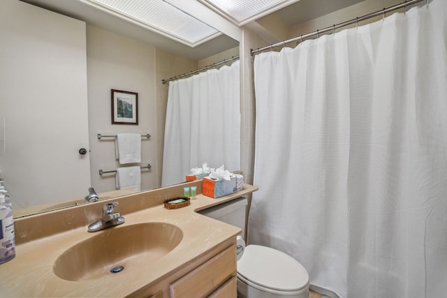 bathroom featuring toilet and vanity