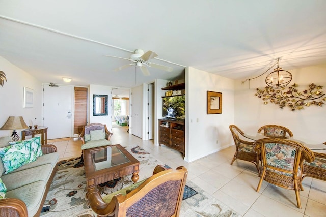 tiled living room featuring ceiling fan with notable chandelier