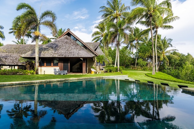 view of swimming pool with a lawn