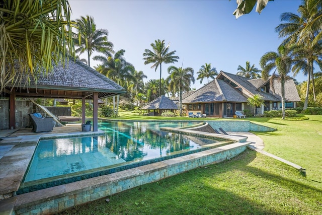 view of pool with a gazebo, a lawn, and a hot tub