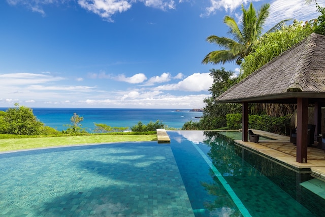 view of swimming pool featuring a patio, a gazebo, and a water view