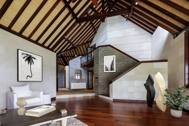 unfurnished living room with high vaulted ceiling, beam ceiling, wooden ceiling, and dark hardwood / wood-style floors