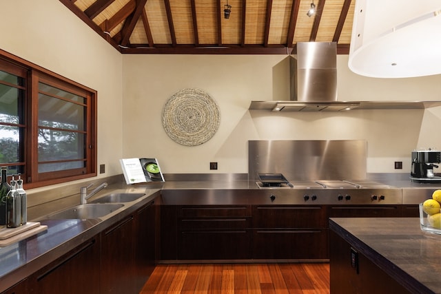 kitchen featuring stainless steel gas cooktop, stainless steel counters, wall chimney range hood, wood ceiling, and dark wood-type flooring