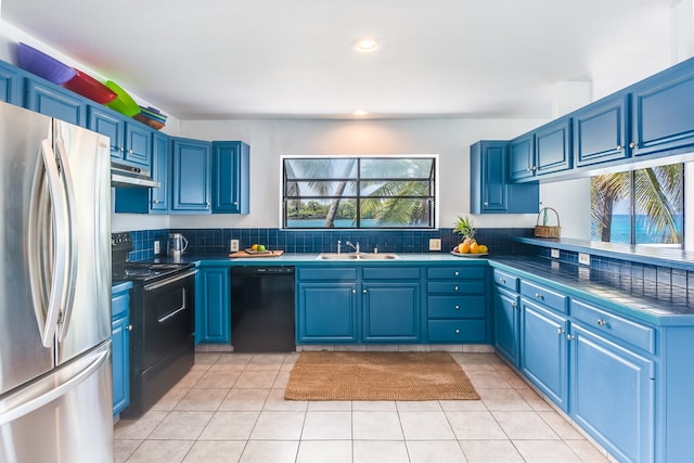 kitchen featuring light tile flooring, a healthy amount of sunlight, black appliances, and sink