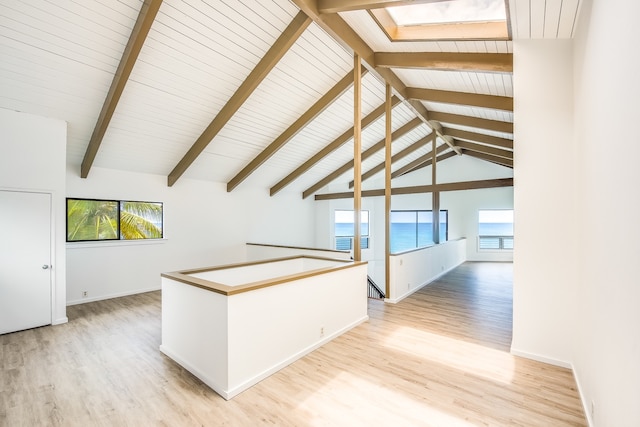 bonus room featuring lofted ceiling with skylight and light hardwood / wood-style flooring