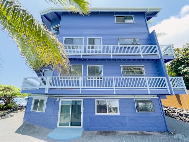 rear view of house featuring a balcony