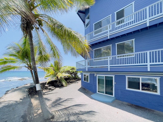 exterior space with a balcony and a water view