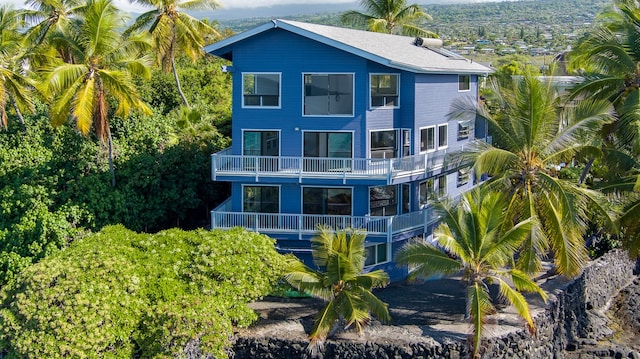 back of property featuring a balcony