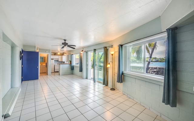 unfurnished sunroom featuring ceiling fan