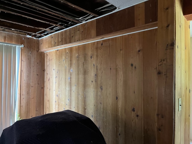 unfurnished bedroom with wooden walls